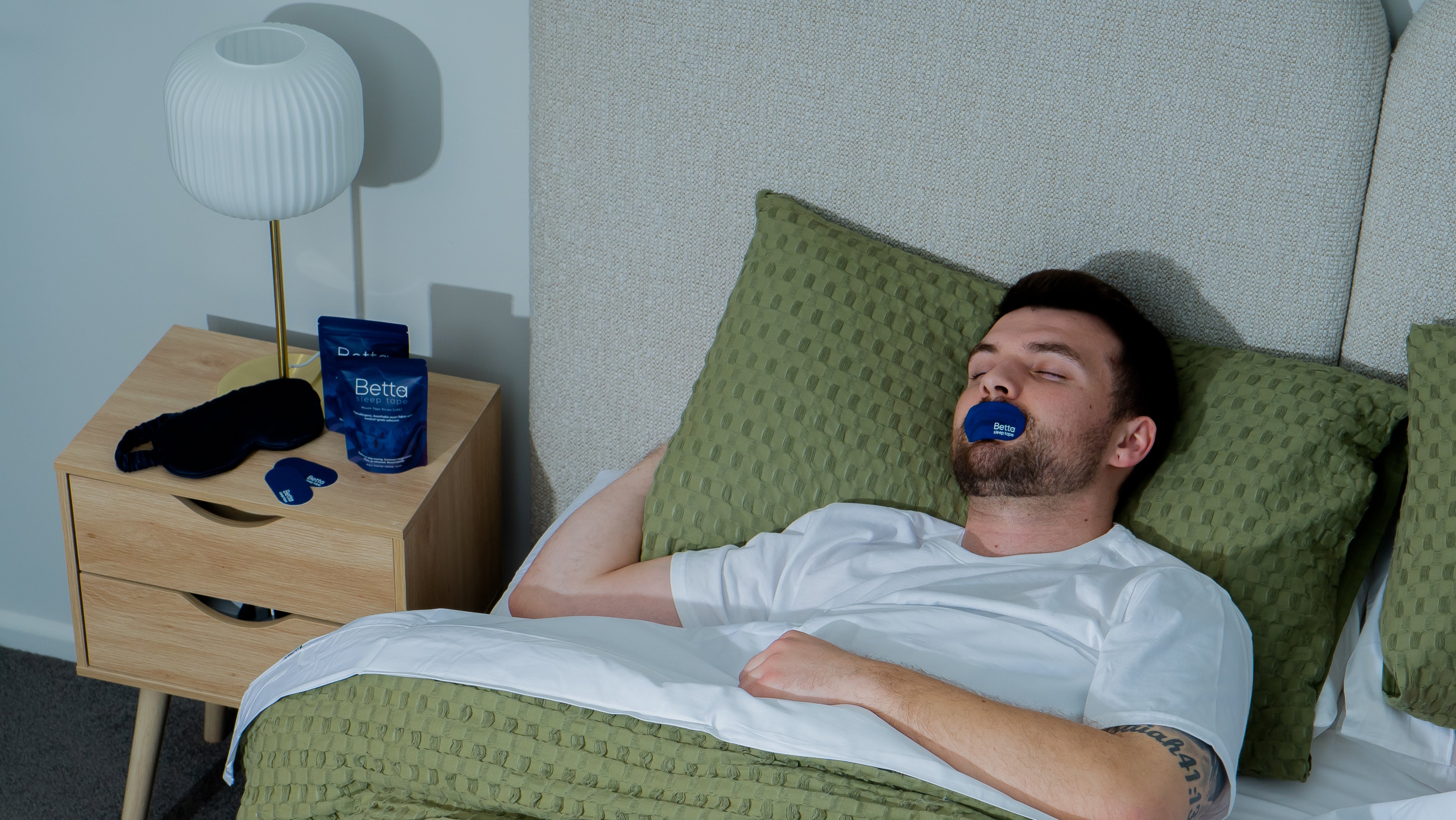 Man sleeping with mouth tape on